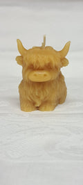 Front view of sitting Highland Coo Candle