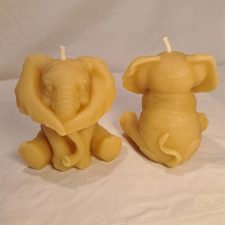 Front and back view of two elephant-shaped candles on a light background