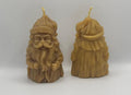 Two beeswax candles shaped like Vintage Santa Claus showing the front and back view, on a white background