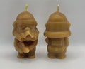 Two beeswax stormtrooper candles on a white background