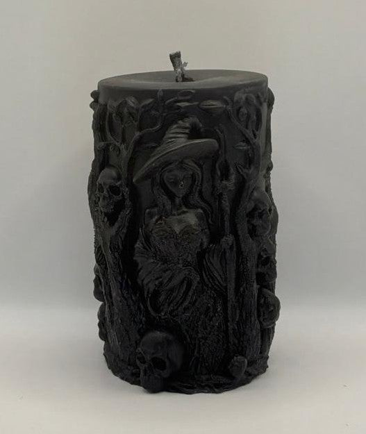 Black decorative candle with intricate designs on a white background