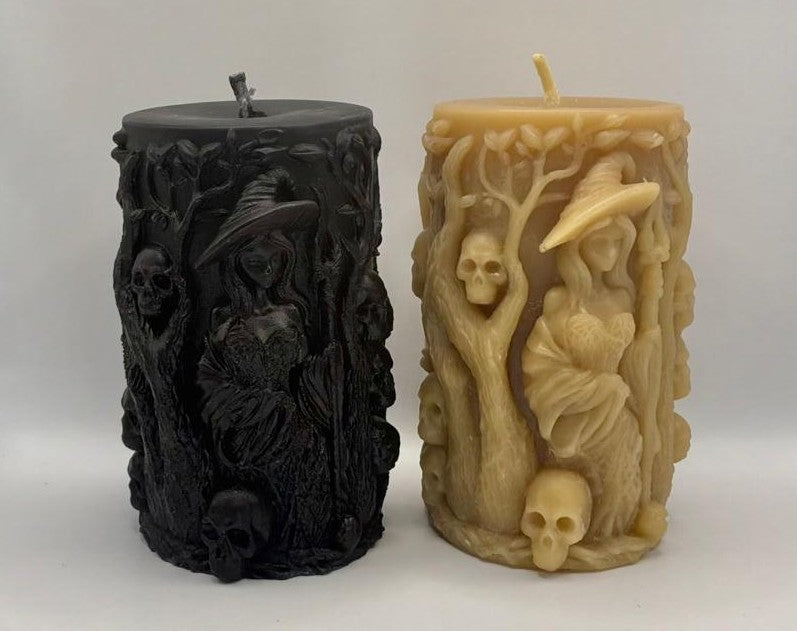 The front view of two intricately designed candles, one black and one natural beeswax, on a white background.